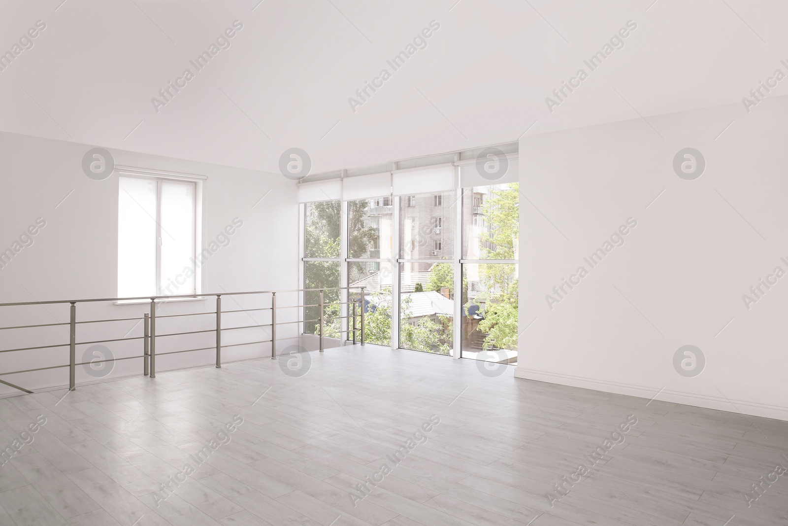 Photo of Empty room with windows and laminated floor