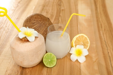 Photo of Composition with glass of coconut water on wooden background