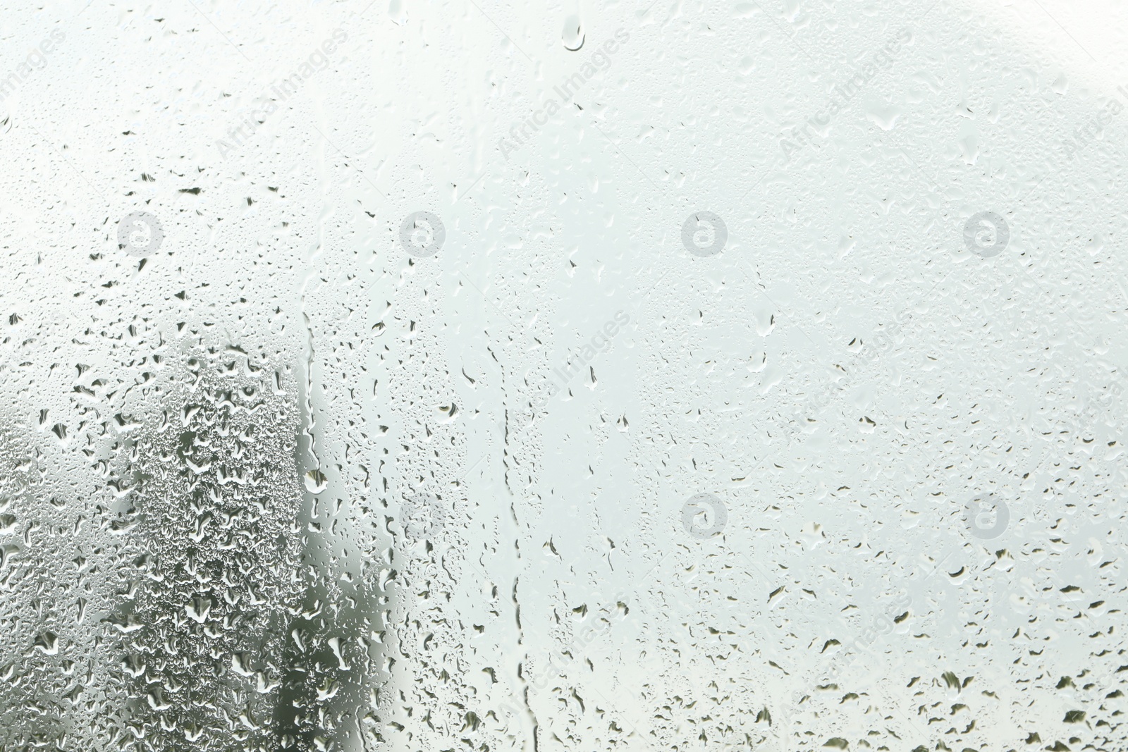 Photo of Window glass with raindrops as background, closeup