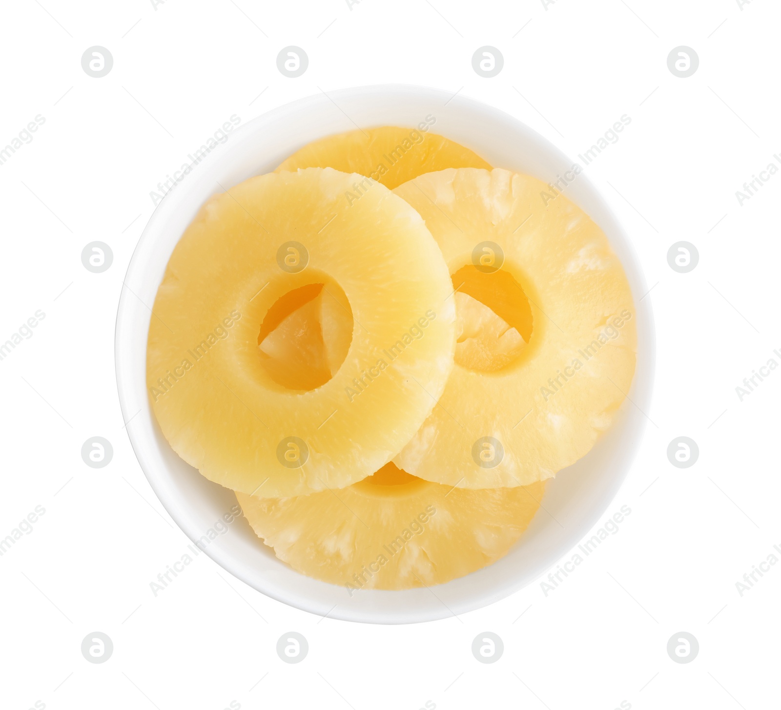 Photo of Delicious canned pineapple rings in bowl on white background, top view