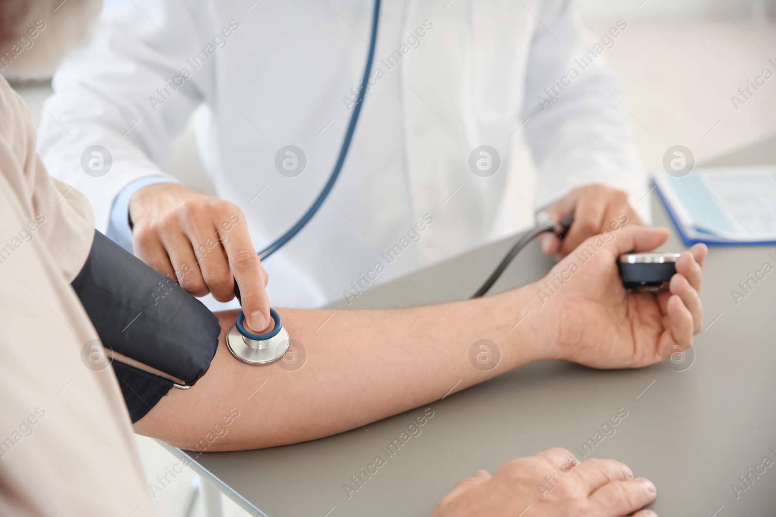 Photo of Doctor measuring patient's blood pressure in hospital