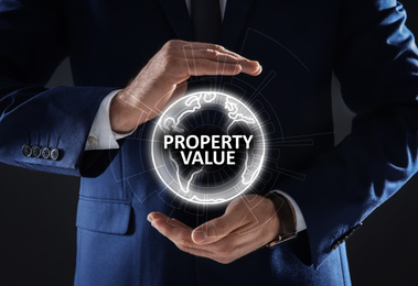 Image of Property value concept. Businessman demonstrating digital world globe