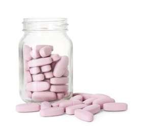 Photo of Bottle and pile of vitamin pills isolated on white