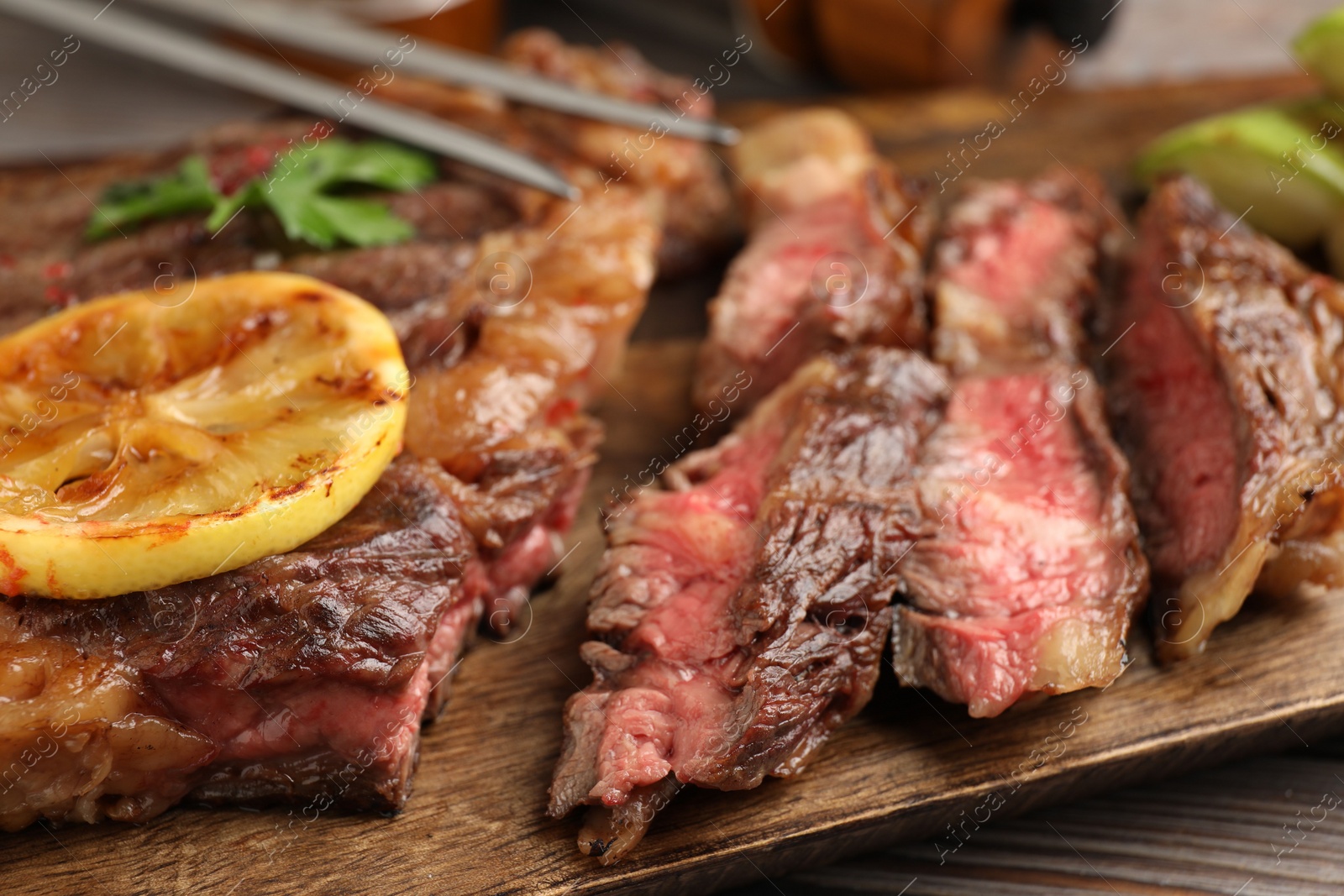 Photo of Delicious grilled beef steak on table, closeup