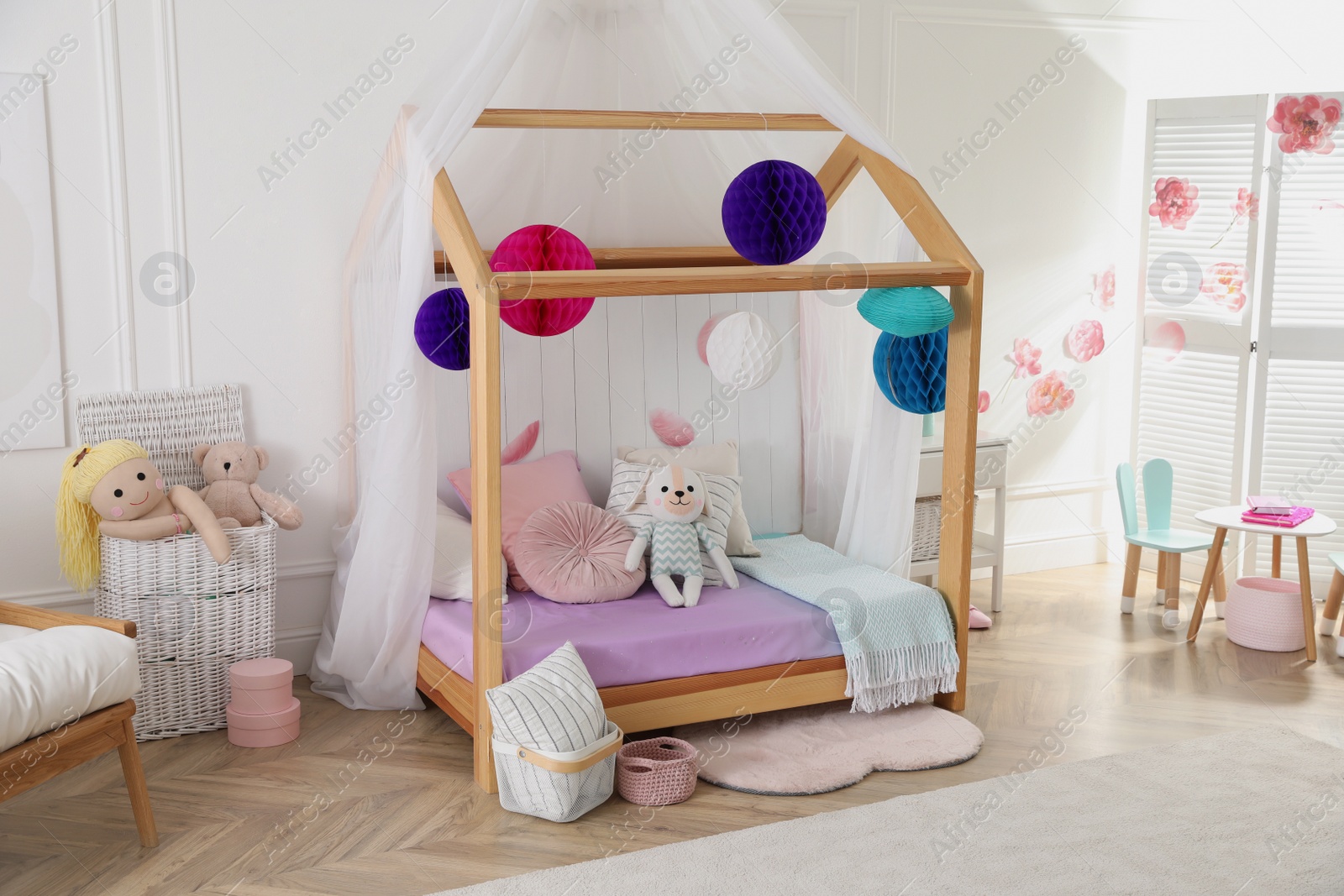 Photo of Stylish room for kid with house bed. Interior design