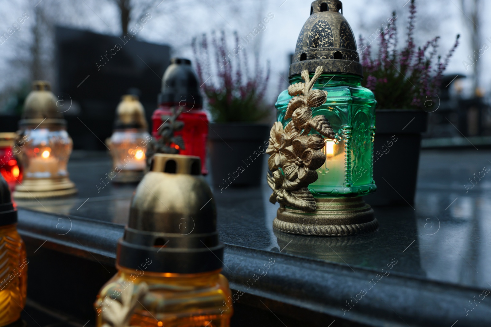 Photo of Grave lights on granite surface at cemetery