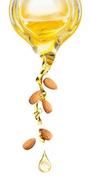 Pouring organic almond oil from glass pitcher and falling nuts on white background. Vertical banner design