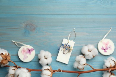 Photo of Flat lay composition with scented sachets on light blue wooden table, space for text