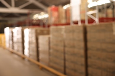 Warehouse with lots of products, blurred view. Wholesale business