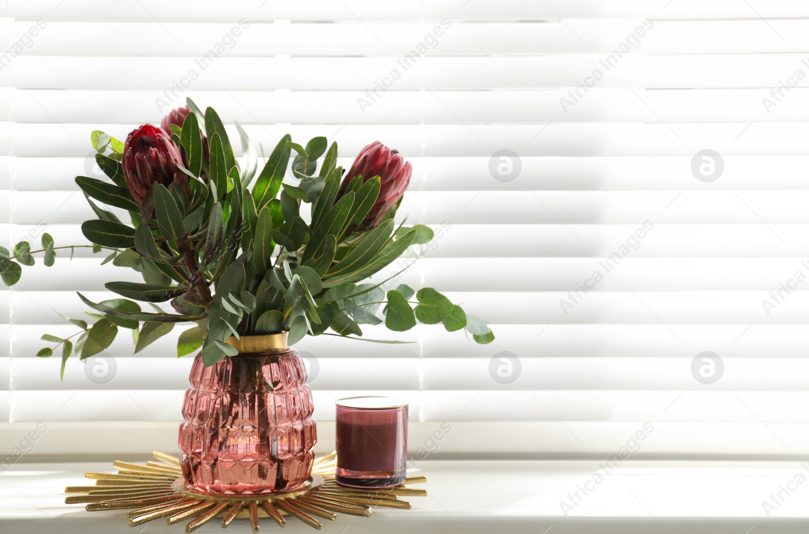 Photo of Vase with bouquet of beautiful Protea flowers on window sill indoors