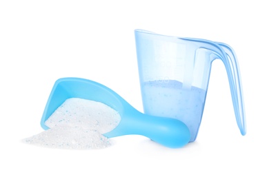 Laundry detergent in plastic measuring containers on white background