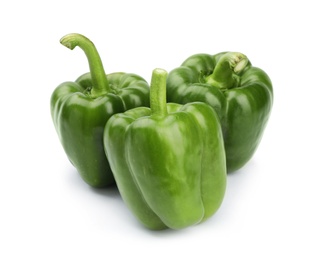 Ripe green bell peppers on white background