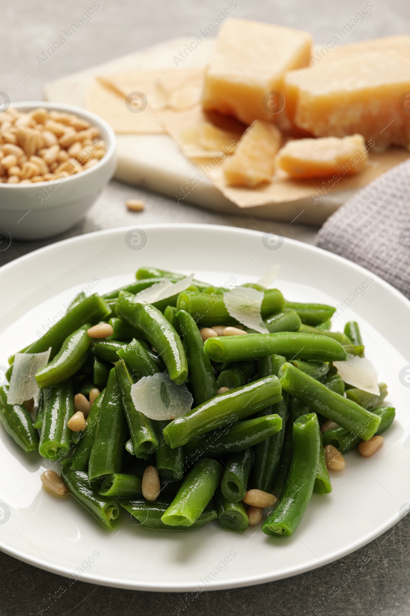 Photo of Tasty salad with green beans served on light grey table