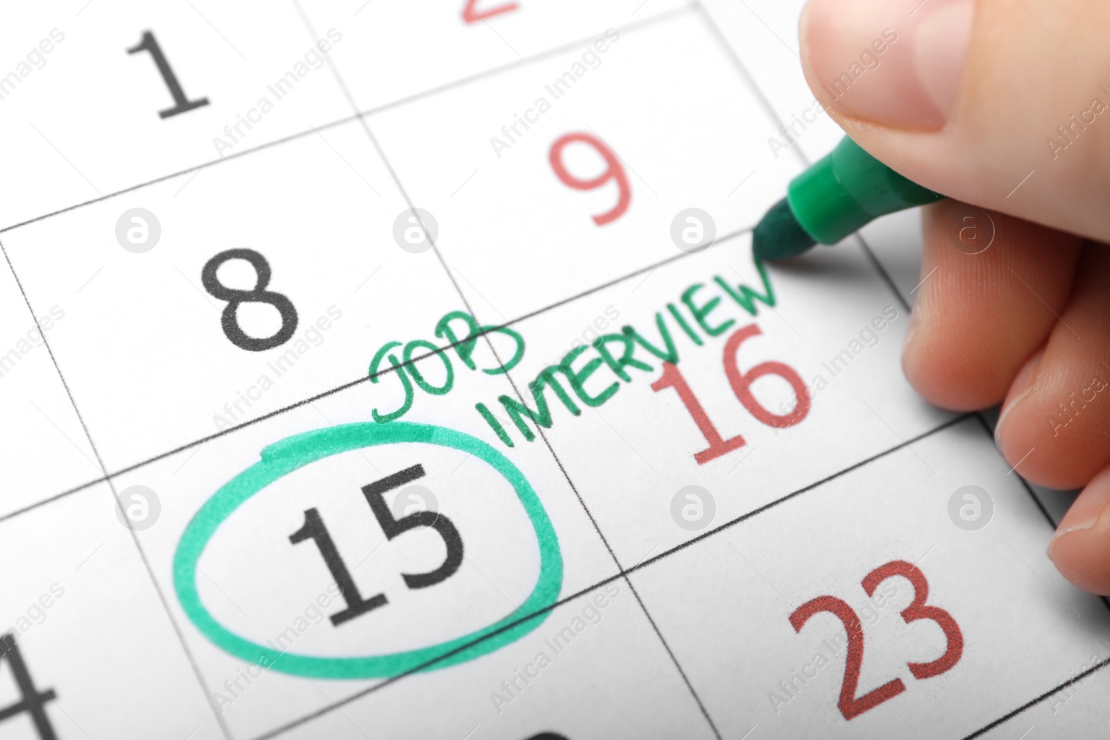 Photo of Woman marking date of job interview in calendar, closeup