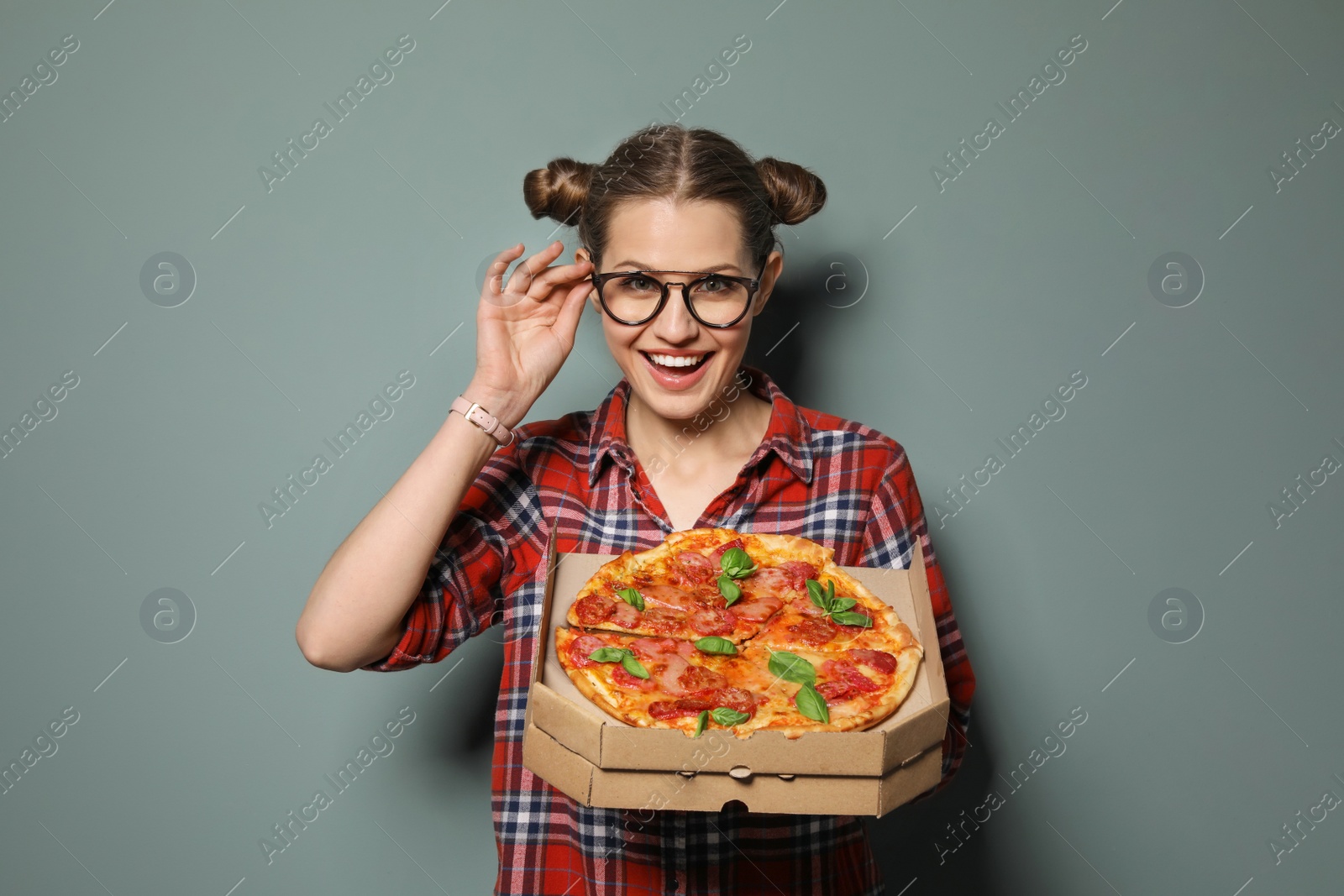 Photo of Attractive young woman with delicious pizza on color background