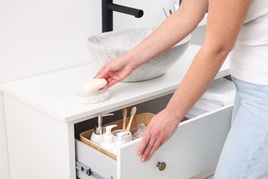 Photo of Bath accessories. Woman with soap indoors, closeup