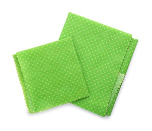 Photo of Green reusable beeswax food wraps on white background, top view
