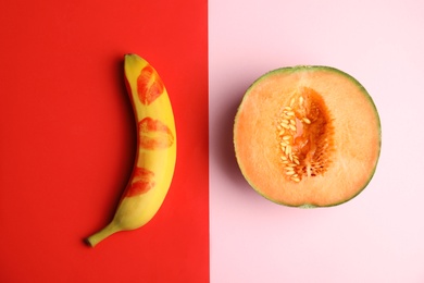 Photo of Flat lay composition with fresh banana and melon on color background. Sex concept