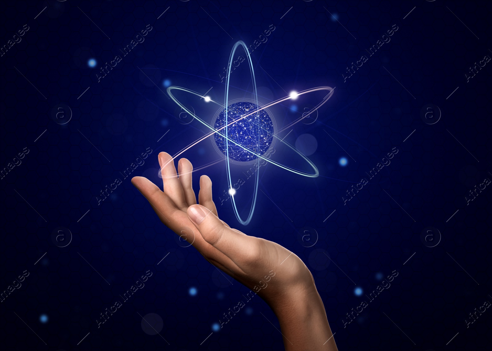 Image of Woman demonstrating virtual model of atom on dark background, closeup