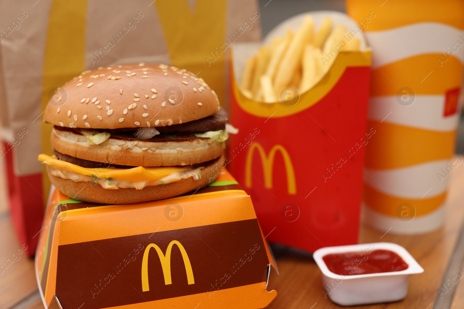 Photo of Lviv, Ukraine - October 9, 2023: McDonald's menu on wooden table outdoors, closeup