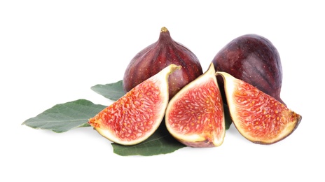 Photo of Fresh juicy purple figs and green leaves on white background