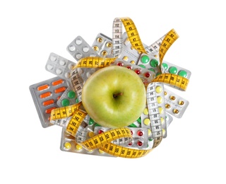 Weight loss pills in blister packs, apple and measuring tape on white background, top view