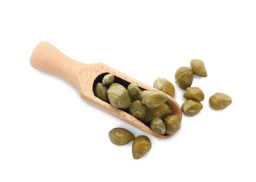 Photo of Wooden scoop and capers on white background, top view