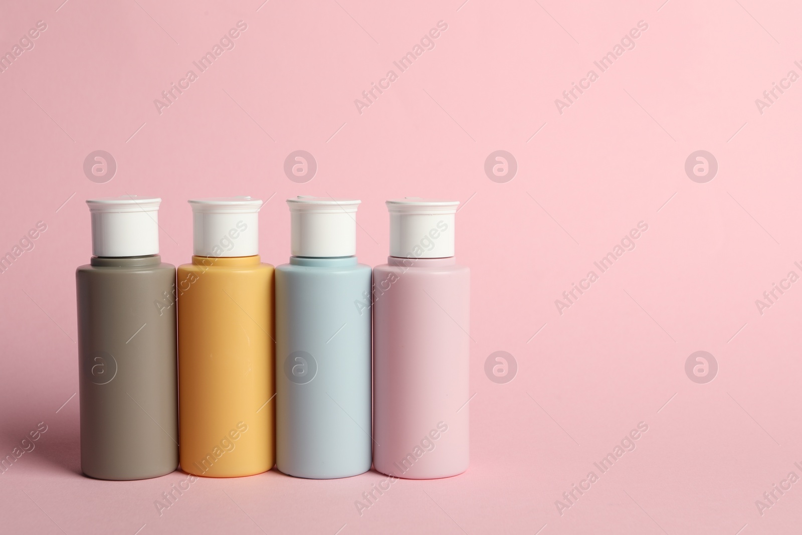 Photo of Cosmetic travel on pink background. Space for text