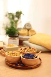 Photo of Dry flowers on wooden table indoors, space for text. Spa time