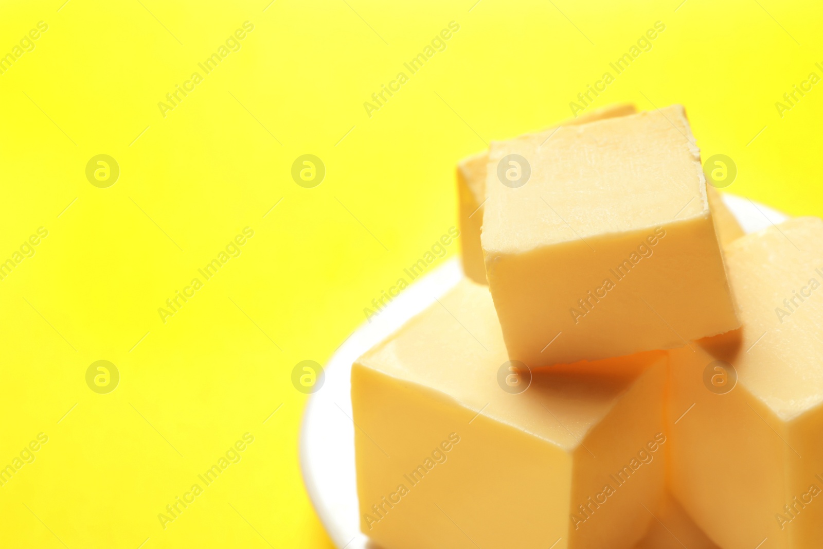 Photo of Plate with fresh butter on color background, closeup. Space for text