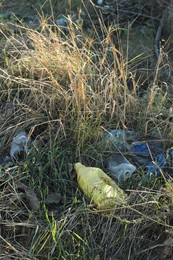 Photo of Different plastic garbage outdoors. Environmental pollution concept