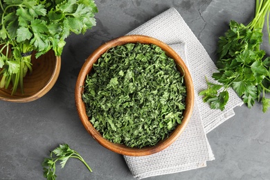 Flat lay composition with fresh and dried parsley on grey stone table