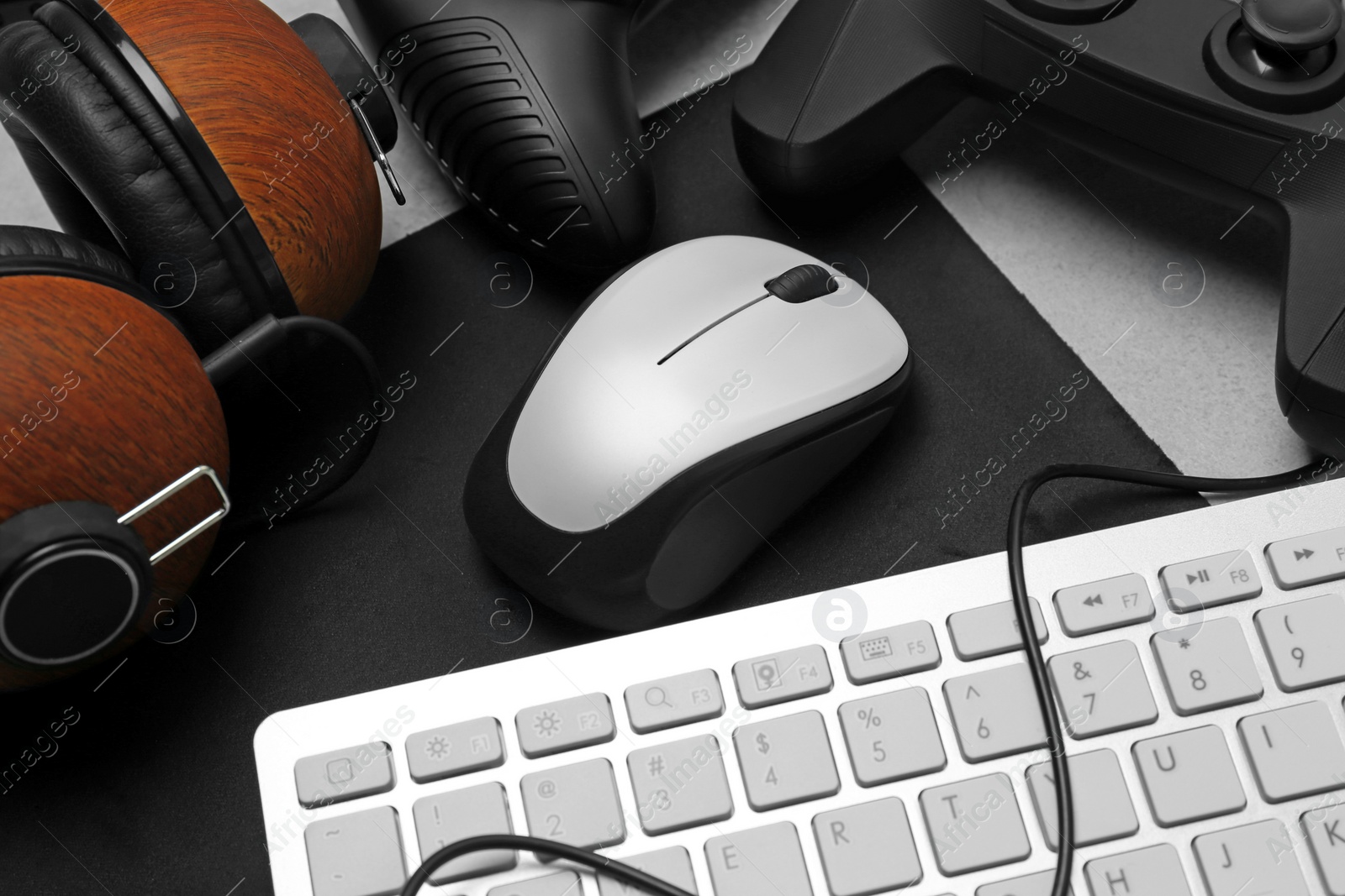 Photo of Modern mouse, headphones and keyboard on table