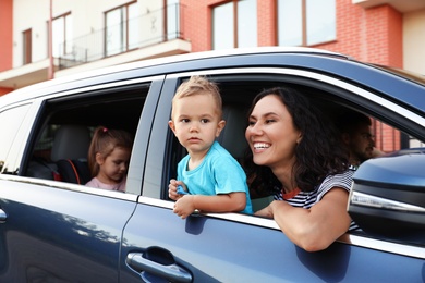 Photo of Happy family traveling by car on summer day