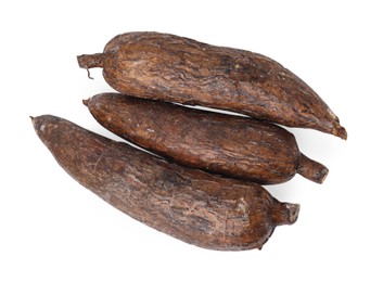 Photo of Three whole ripe cassava roots isolated on white, top view