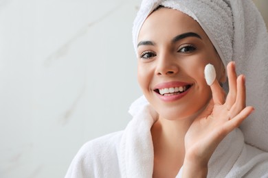 Photo of Woman using silkworm cocoon in skin care routine at home. Space for text