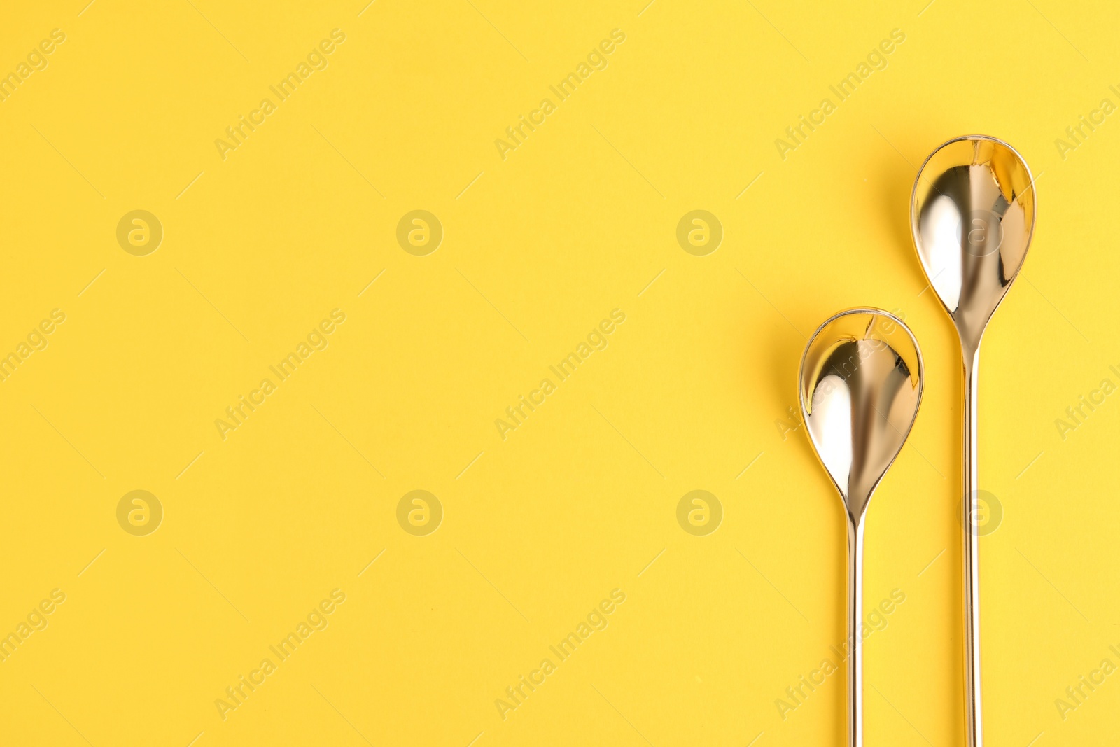 Photo of Clean tea spoons and space for text on color background, flat lay