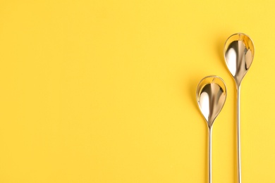 Photo of Clean tea spoons and space for text on color background, flat lay