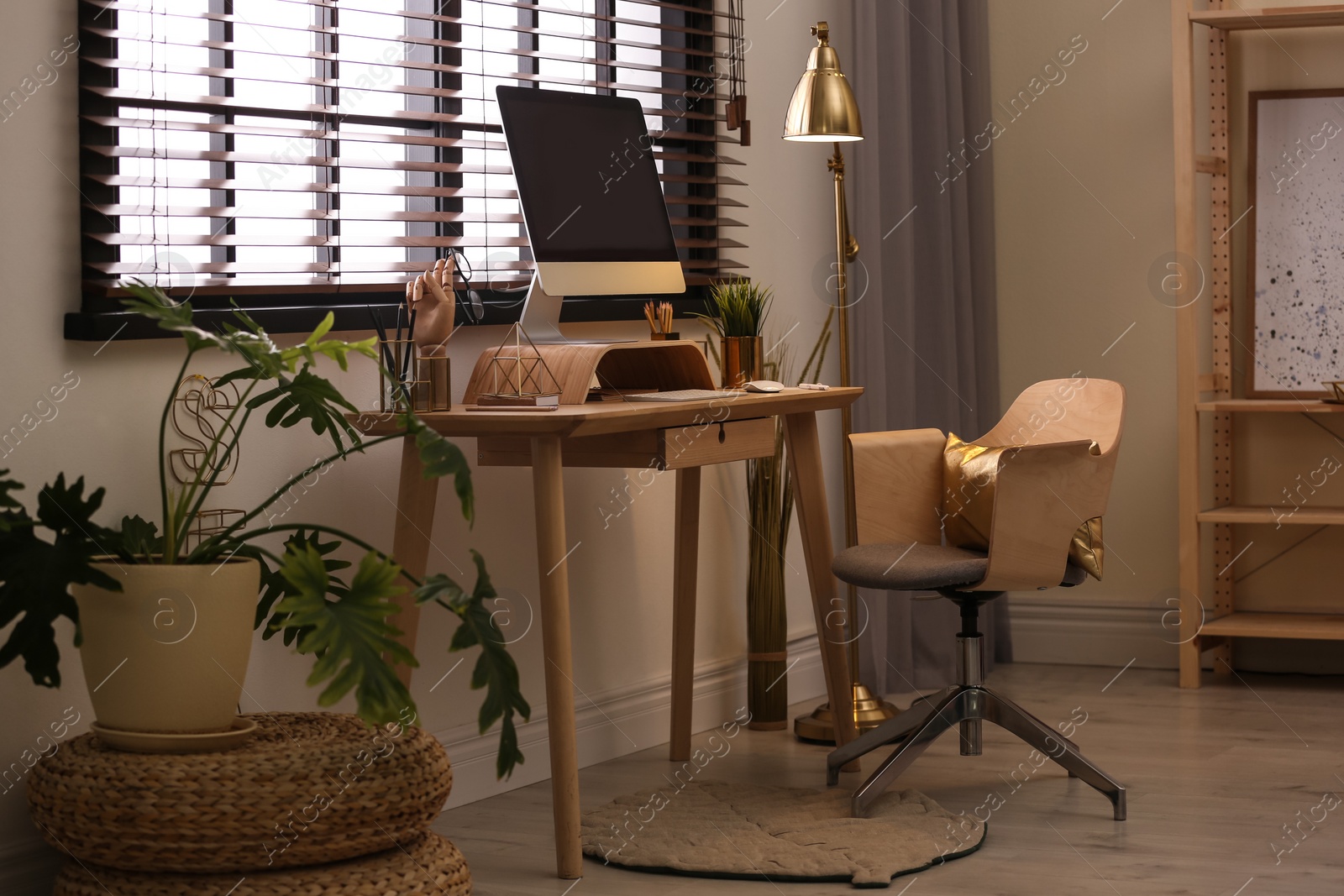 Photo of Stylish room interior with modern workplace at window