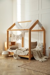 Photo of Stylish child room interior with house bed