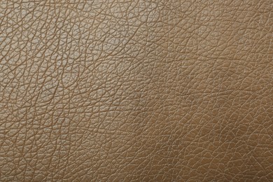Photo of Texture of beige leather as background, top view