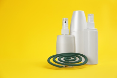 Photo of Set of different insect repellents on yellow background. Space for text