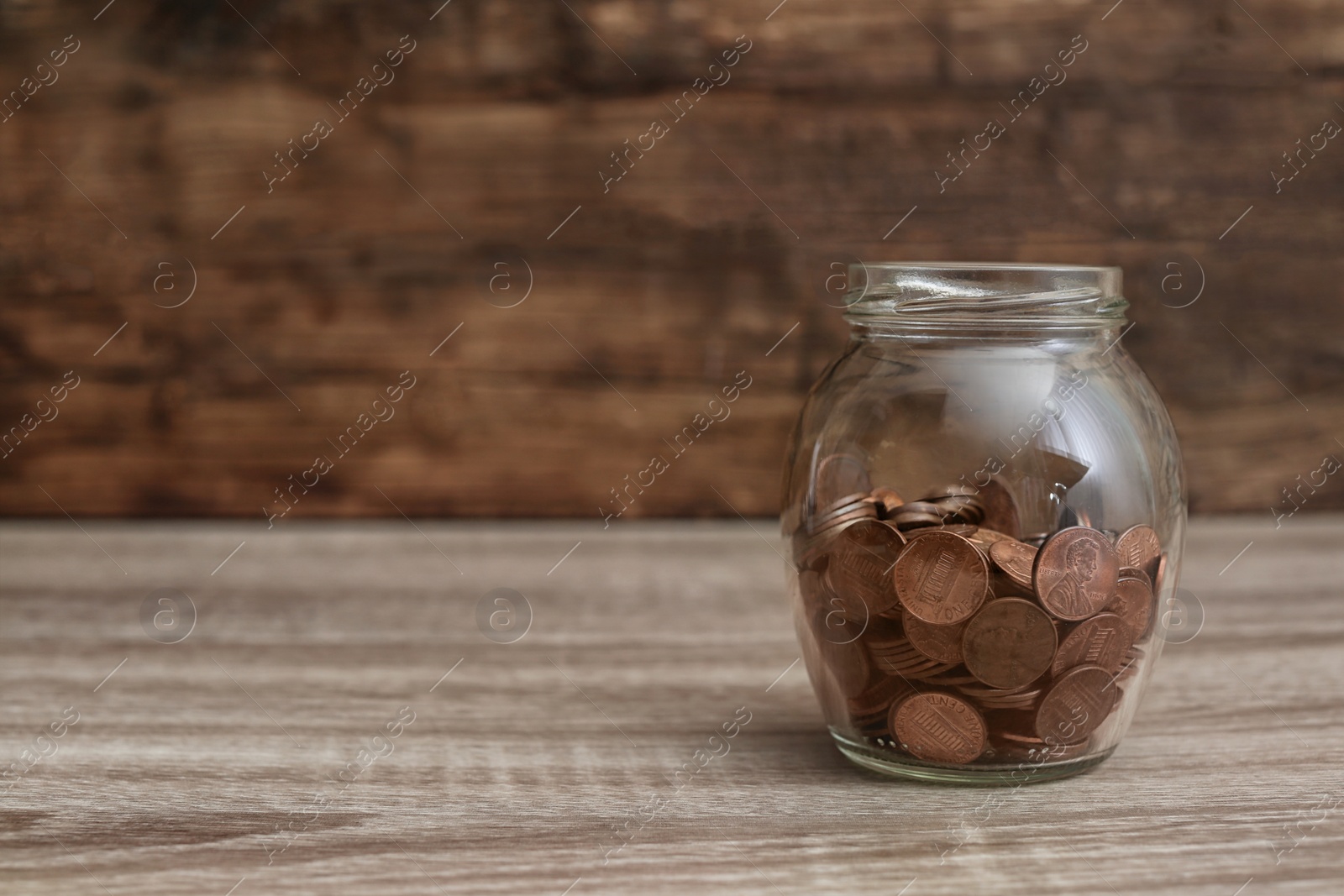 Photo of Donation jar with coins on table. Space for text