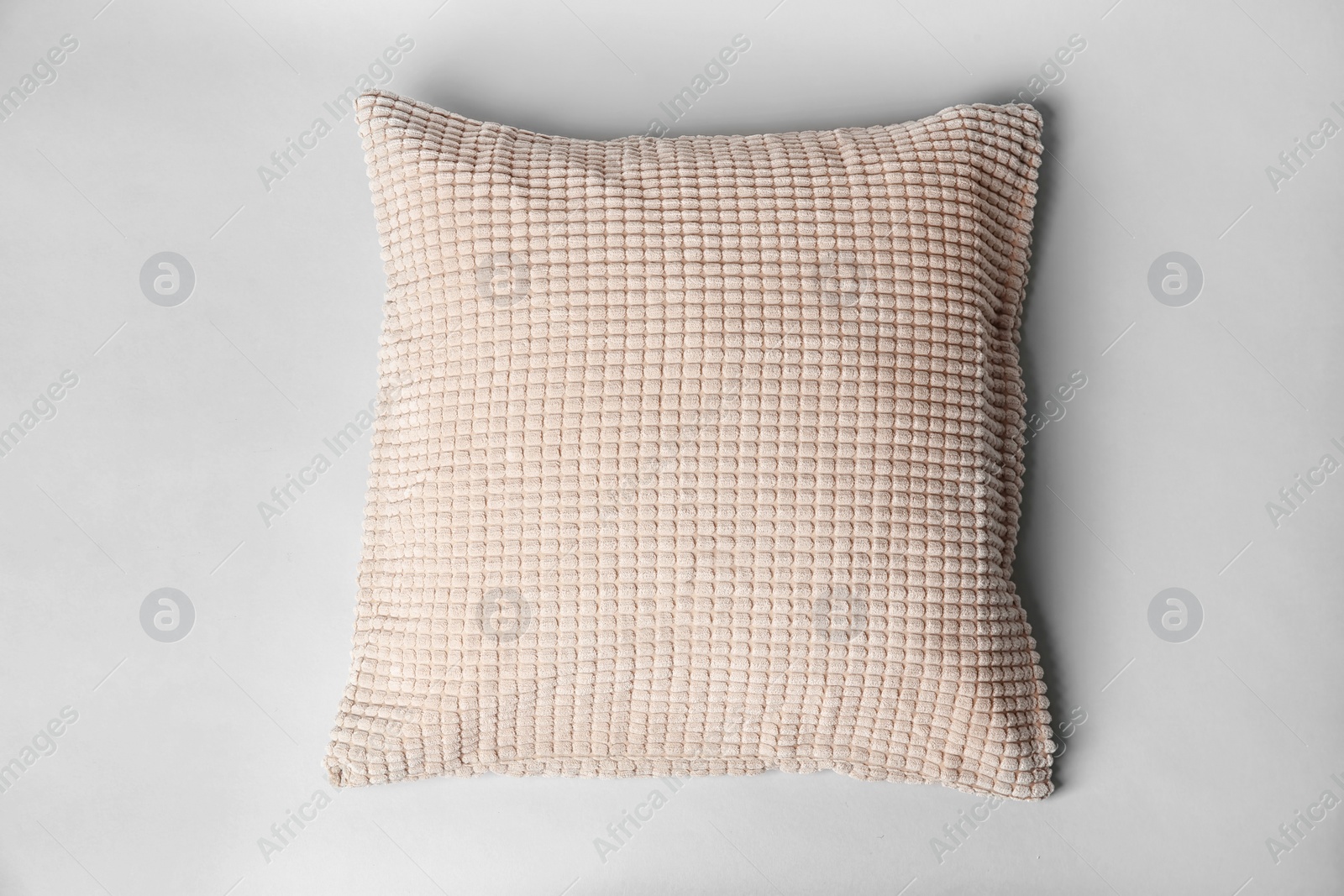 Photo of Soft decorative pillow on light background