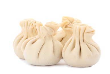 Photo of Heap of raw dumplings with tasty filling on white background