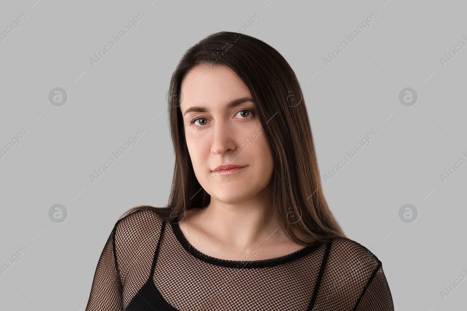 Photo of Portrait of beautiful young woman on light grey background