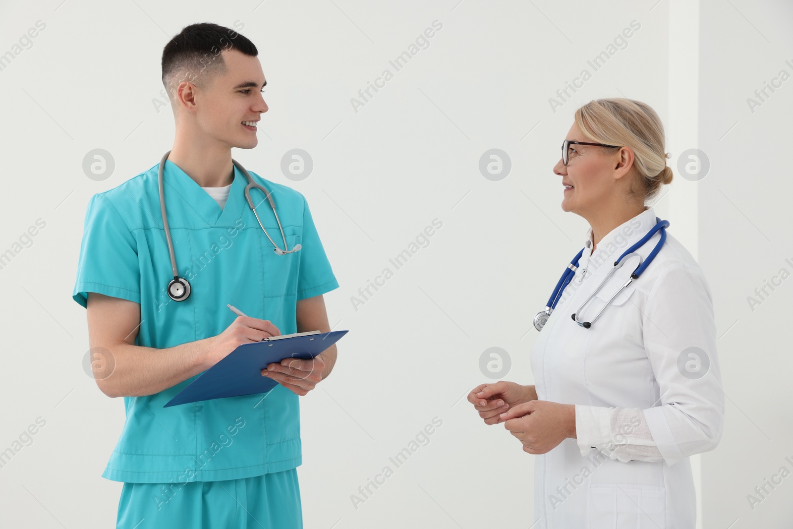 Photo of Medical doctors in uniforms having discussion indoors