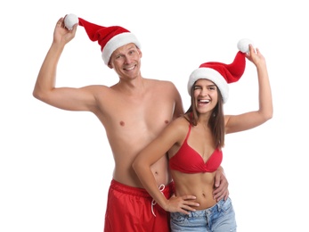 Happy couple with Santa hats together on white background. Christmas vacation