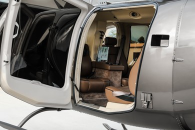 New helicopter with open cabin doors and leather seats