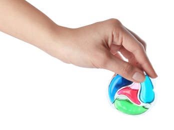 Woman holding laundry capsule on white background, closeup